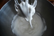 Whip egg whites until stiff peaks form